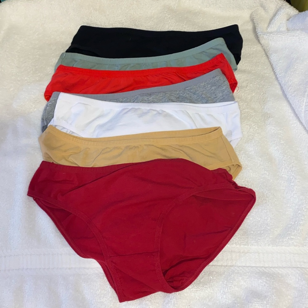 Seven pairs of size medium cheeky bikini panties, 95% cotton. 5% elastane